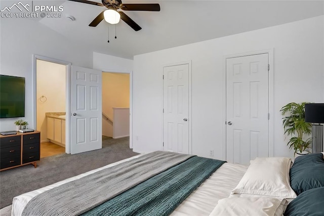 carpeted bedroom with ceiling fan, connected bathroom, and multiple closets