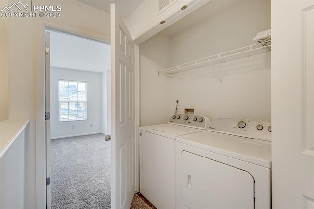 washroom with washing machine and dryer and carpet floors