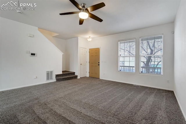 unfurnished living room with ceiling fan and carpet