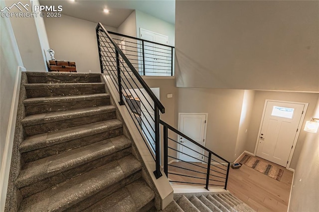 stairway with hardwood / wood-style floors