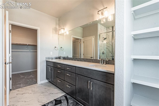 bathroom with a shower with shower door and vanity