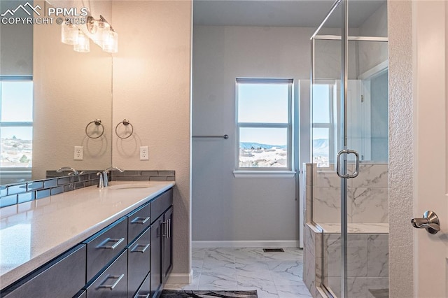 bathroom with a shower with door and vanity