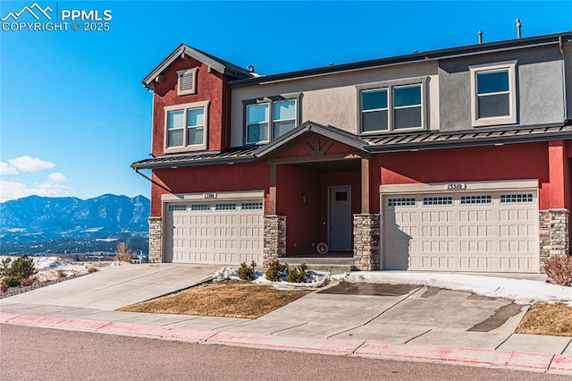 view of property with a garage and a mountain view