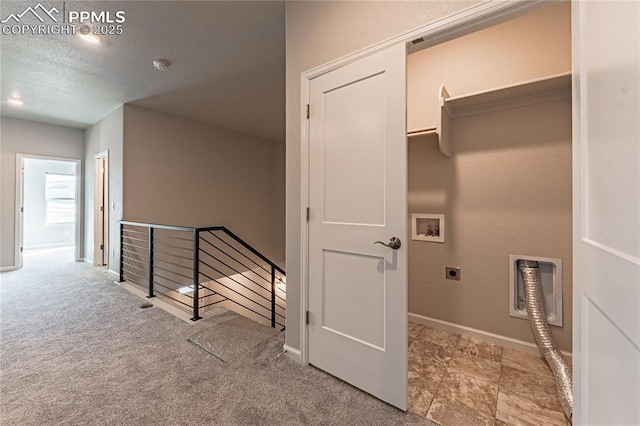 laundry room featuring light carpet, washer hookup, electric dryer hookup, and a textured ceiling