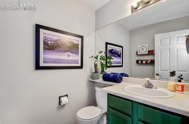 bathroom with toilet and vanity