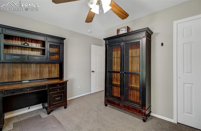 carpeted home office featuring ceiling fan