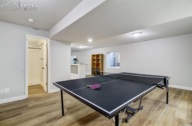 recreation room with light hardwood / wood-style flooring