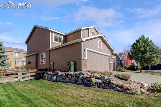 view of side of property with a yard and a garage