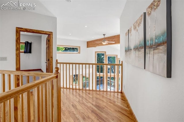 hall with light hardwood / wood-style floors and vaulted ceiling with beams