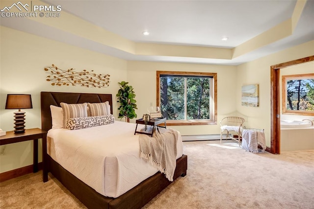 carpeted bedroom featuring baseboard heating and a raised ceiling