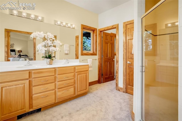 bathroom featuring a shower with door and vanity