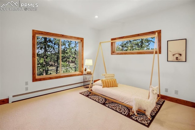 sitting room featuring a baseboard heating unit and carpet floors