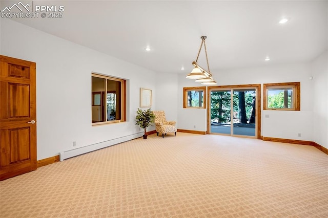 carpeted empty room featuring baseboard heating