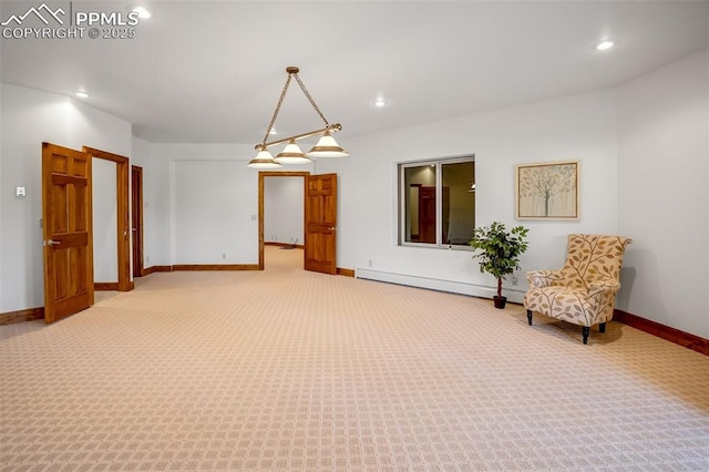 sitting room featuring baseboard heating and carpet