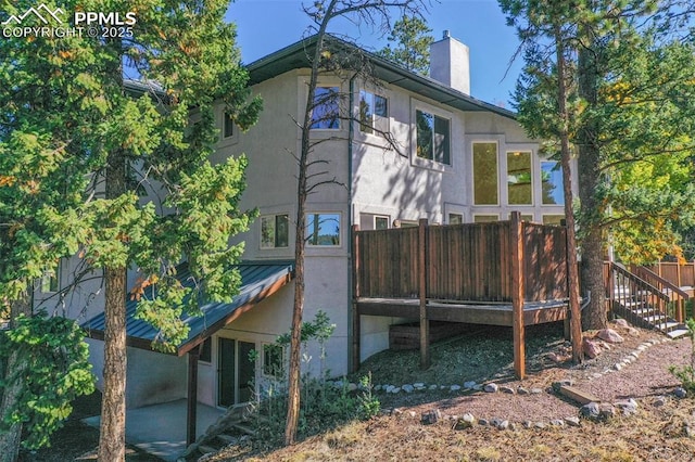 rear view of house featuring a deck