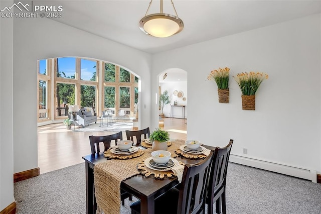 dining room featuring carpet flooring and a baseboard heating unit