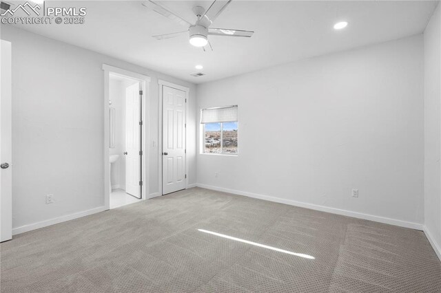 unfurnished bedroom with ensuite bathroom, ceiling fan, and carpet