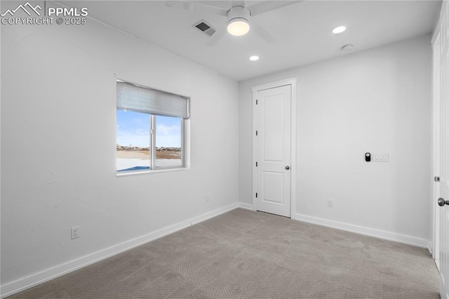 carpeted spare room with ceiling fan