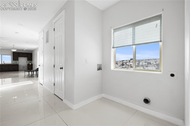 laundry area with washer hookup, hookup for an electric dryer, and light tile patterned floors