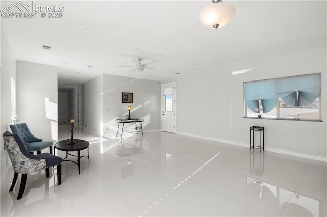 tiled living room with ceiling fan and a healthy amount of sunlight