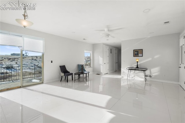 interior space featuring ceiling fan and light tile patterned floors