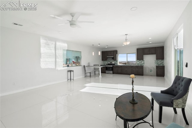 living room with light tile patterned flooring, ceiling fan, and sink