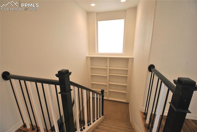 staircase with wood-type flooring