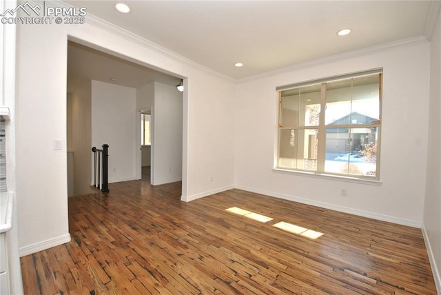 unfurnished room featuring crown molding and dark wood-type flooring