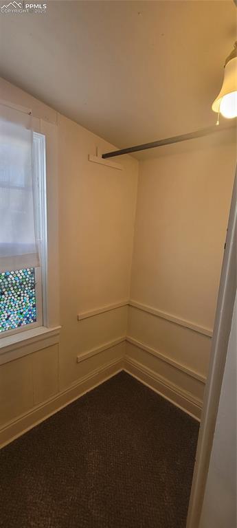 carpeted empty room featuring baseboards