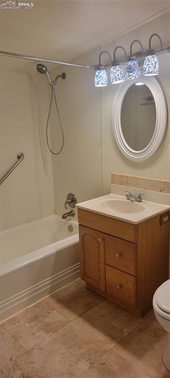 bathroom featuring toilet, tile patterned flooring, bathtub / shower combination, and vanity