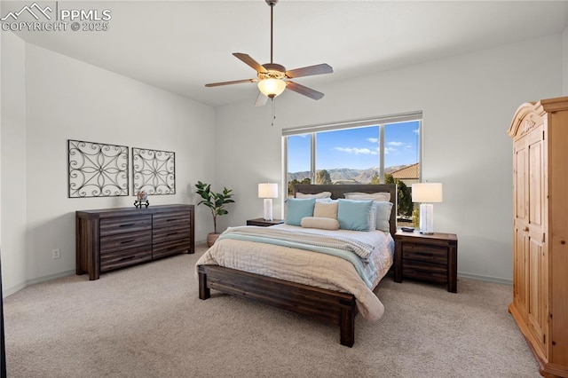 bedroom with ceiling fan, light colored carpet, and a closet