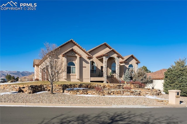 mediterranean / spanish-style home with a mountain view