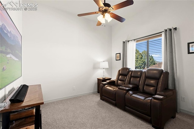 cinema room featuring ceiling fan and light colored carpet