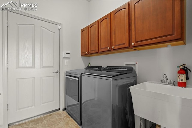 laundry room featuring cabinets, separate washer and dryer, and sink