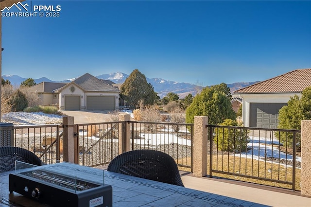 view of patio / terrace featuring a garage and a mountain view