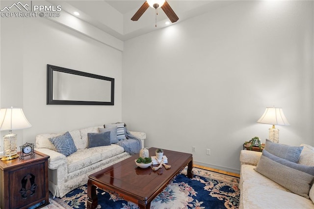 living room with ceiling fan and hardwood / wood-style flooring