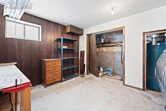 bedroom featuring a closet and wooden walls