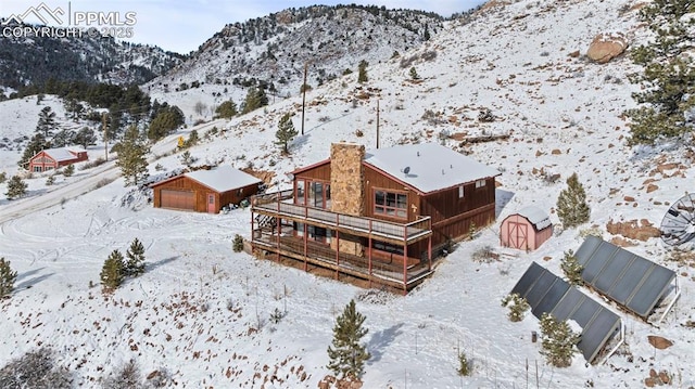 snowy aerial view featuring a mountain view