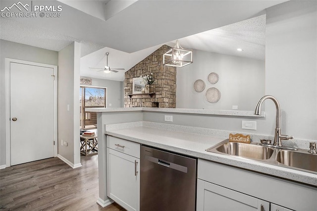 kitchen with pendant lighting, a textured ceiling, dishwasher, white cabinetry, and sink