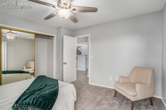 carpeted bedroom with a textured ceiling, a closet, and ceiling fan