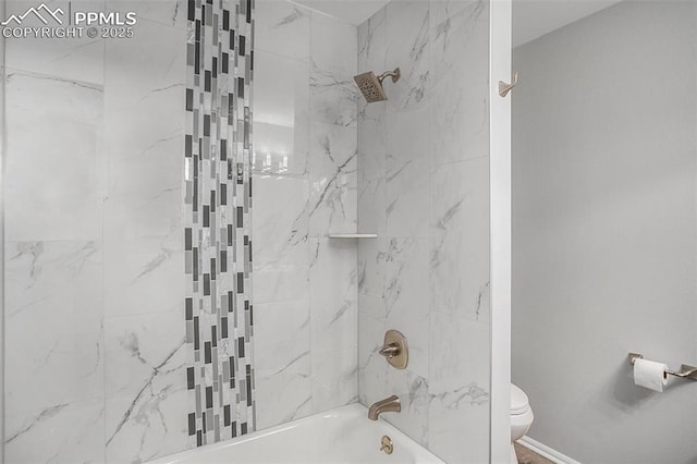 bathroom featuring toilet and tiled shower / bath