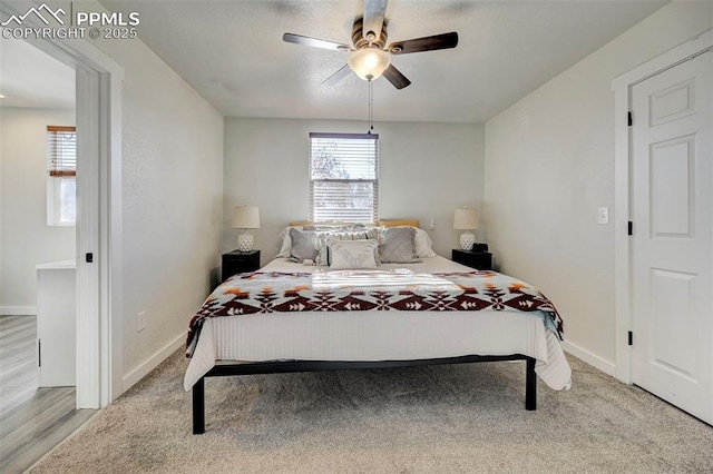 bedroom with ceiling fan and light carpet