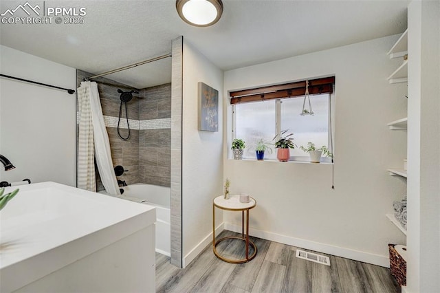 bathroom with shower / bath combination with curtain and hardwood / wood-style flooring