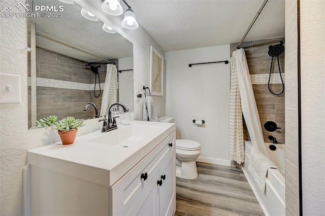 full bathroom featuring toilet, shower / bathtub combination with curtain, wood-type flooring, a textured ceiling, and vanity