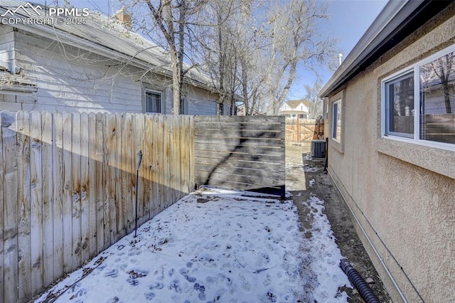 yard layered in snow with central air condition unit