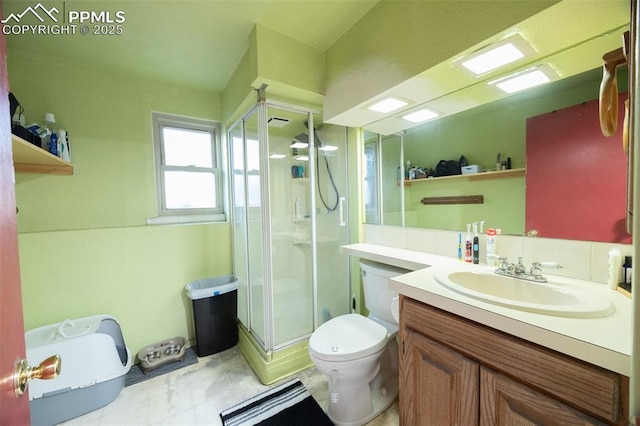 2841 Pinnacle Dr, Colorado Springs, CO 80910 - bathroom with a shower with door, toilet, and vanity