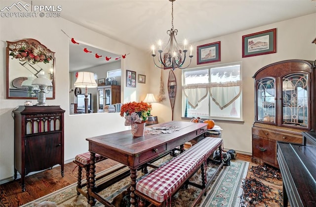 dining space with an inviting chandelier and dark hardwood / wood-style floors