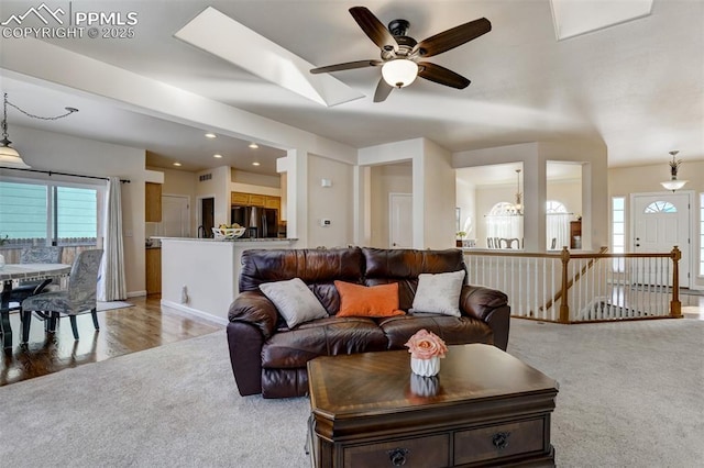 living room featuring light carpet and a chandelier