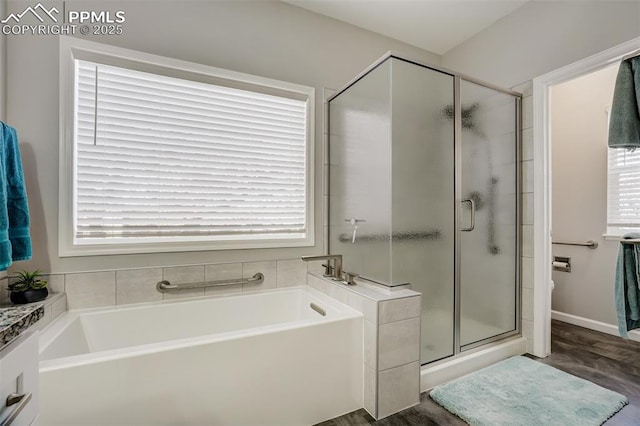 bathroom featuring independent shower and bath