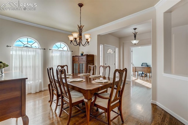 dining room featuring a chandelier, crown molding, and wood-type flooring